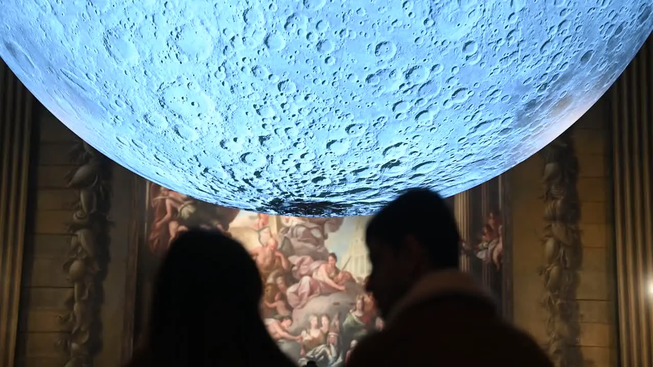 Kiss in front of the moon Old Royal Naval College London United Kingdom