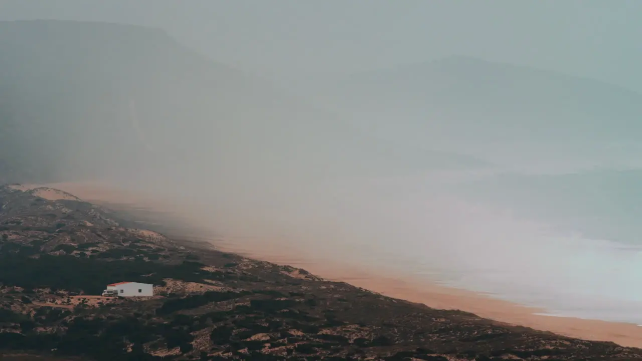 Ocean coast and mountains in the thick fog