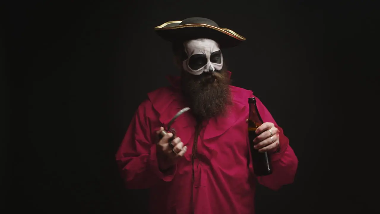 Drunk bearded man dressed up like a pirate with a hook