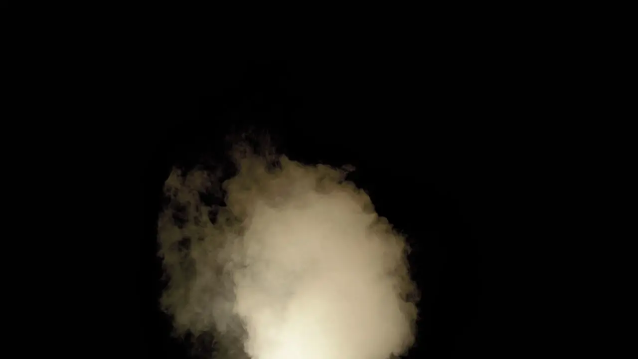 Medium sized smoke cloud drifting right lit with pulsating simulated fire light