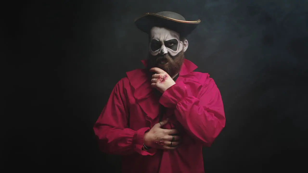 Man dressed up like a scary pirate in red shirt and with a hat