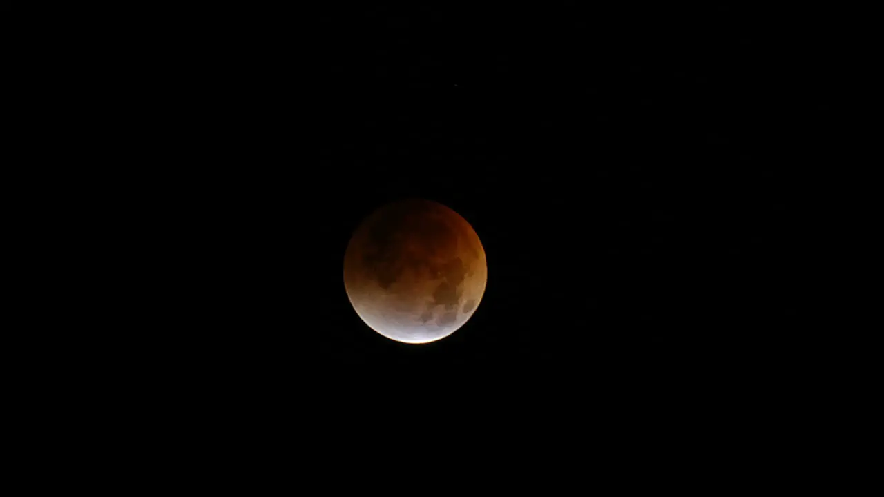 Time lapse of a lunar eclipse with moon moving across frame 2