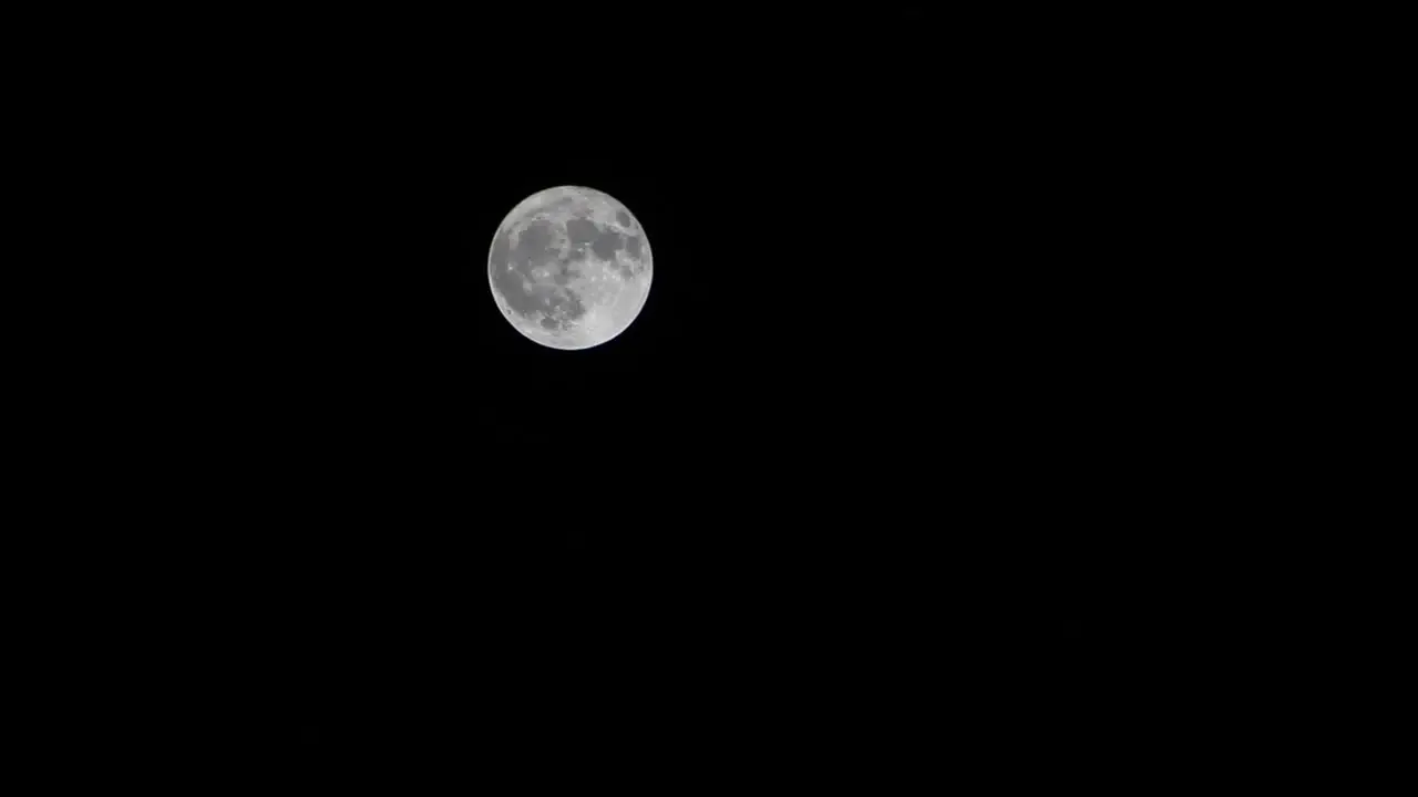 Moon moves slowly across night sky time lapse