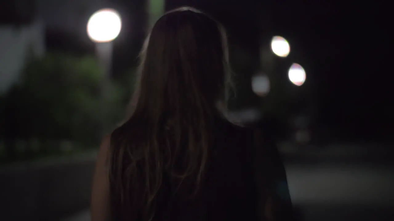 Woman walking alone in night street