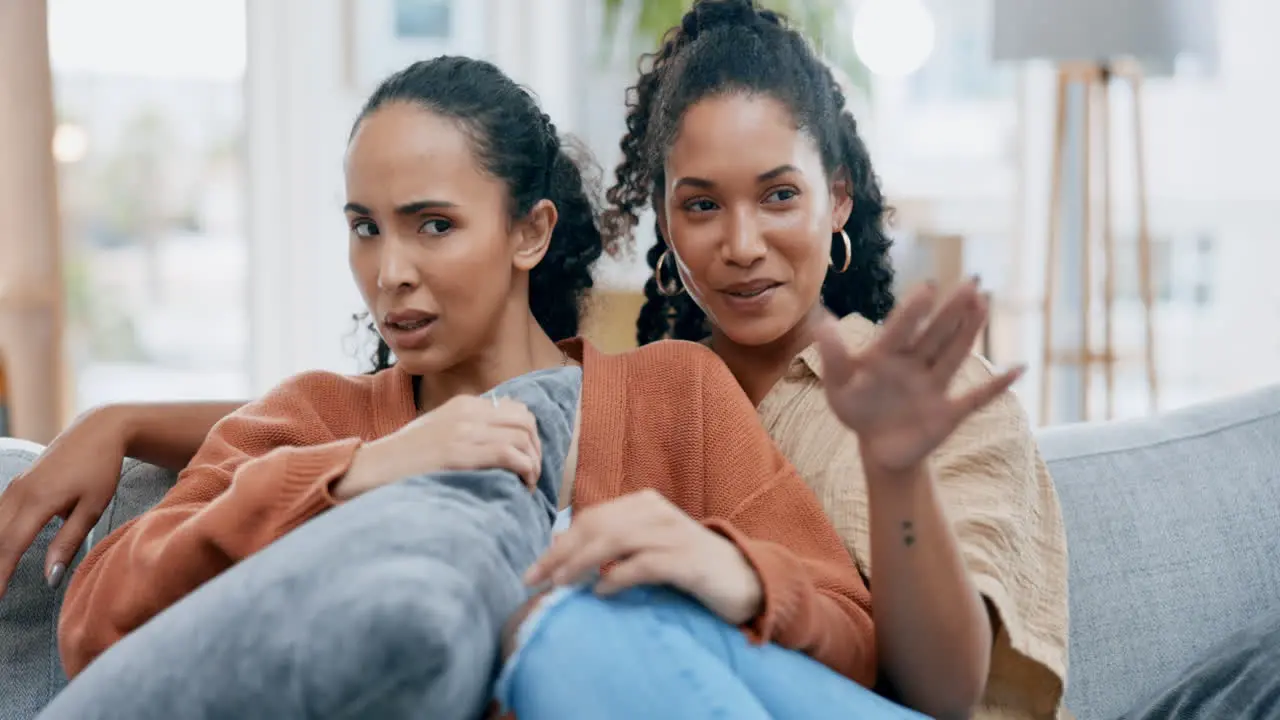 Lesbian couple watching a horror movie with a jump