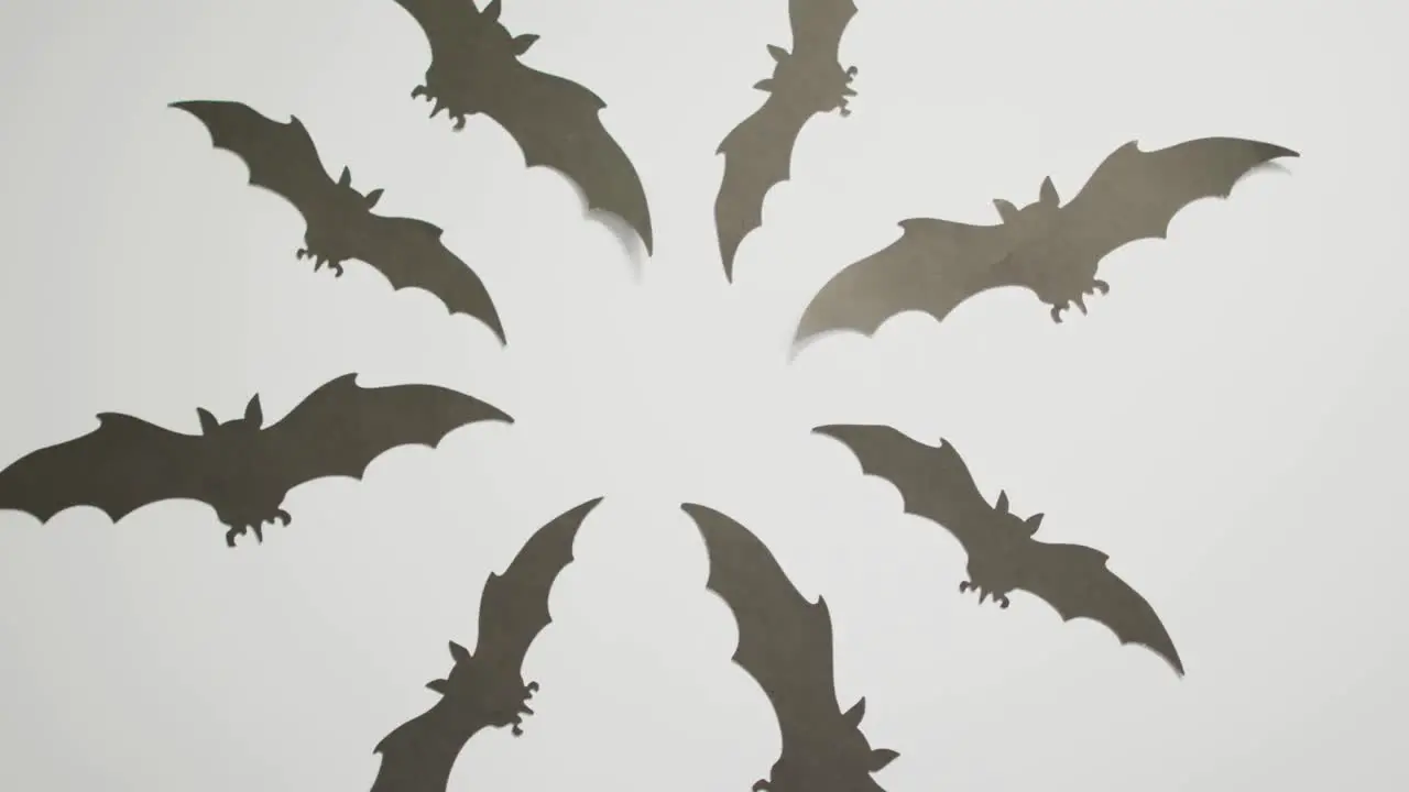 Digital animation of multiple halloween bat icons against grey background