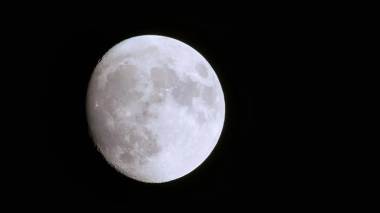 Incredible telephoto view of rare full blue supermoon moon rise foreground dark shapes brush past