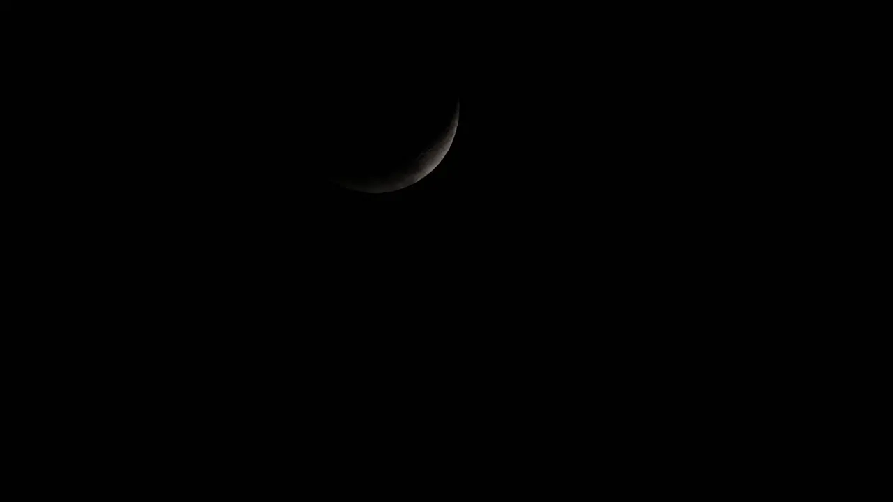 Waxing Crescent Moon covered with clouds then reveals again as it descends from the sky