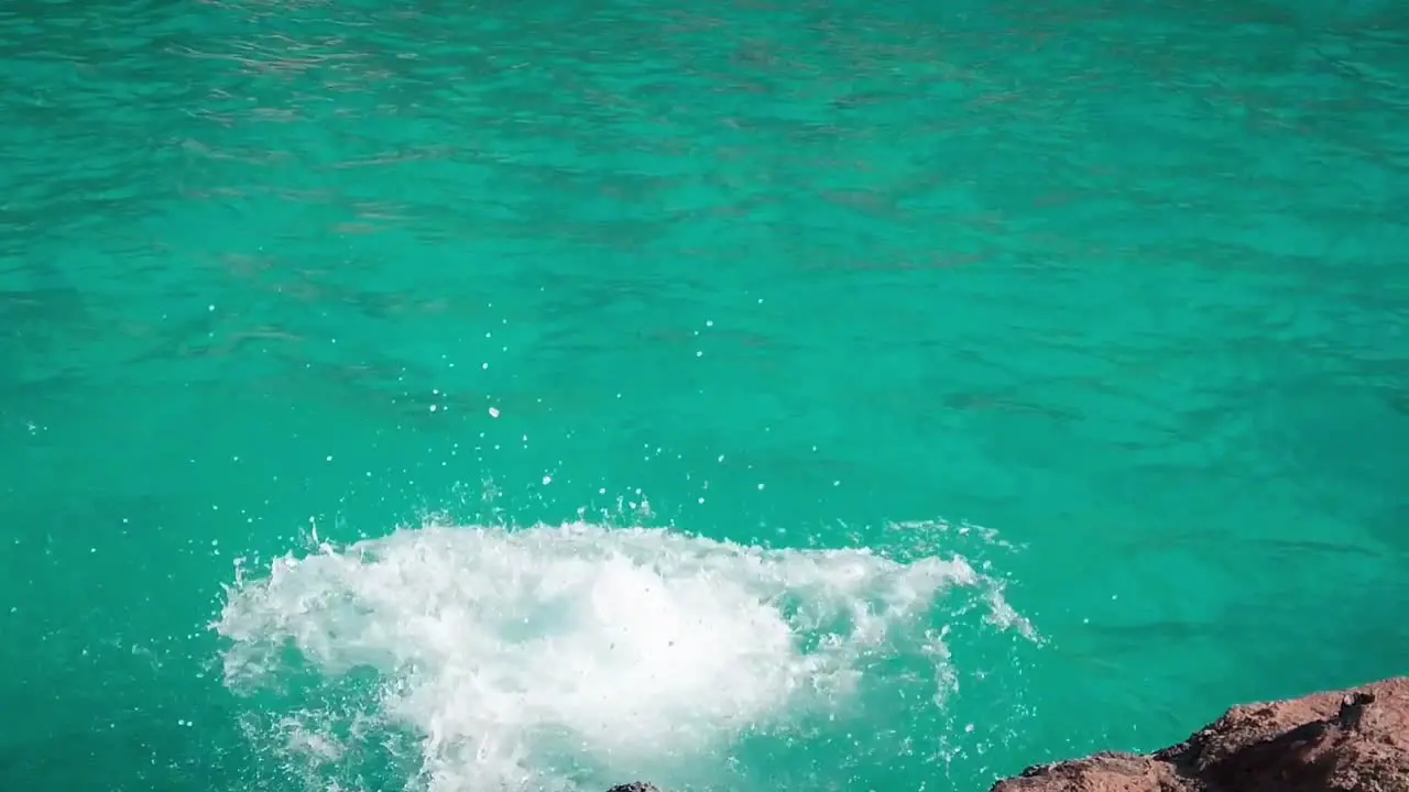 man jumping into sea water