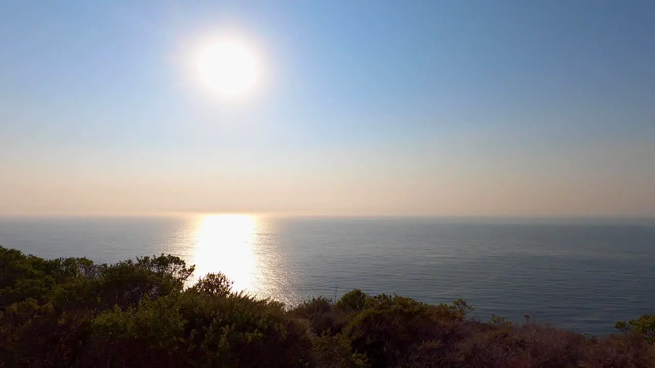 Still shot of the sun beginning to set over the California cliffs in Half Moon Bay 4K