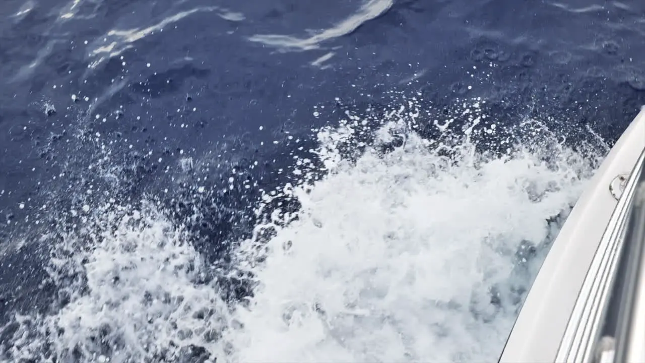 Top down view of boat's wake as it moves through deep ocean