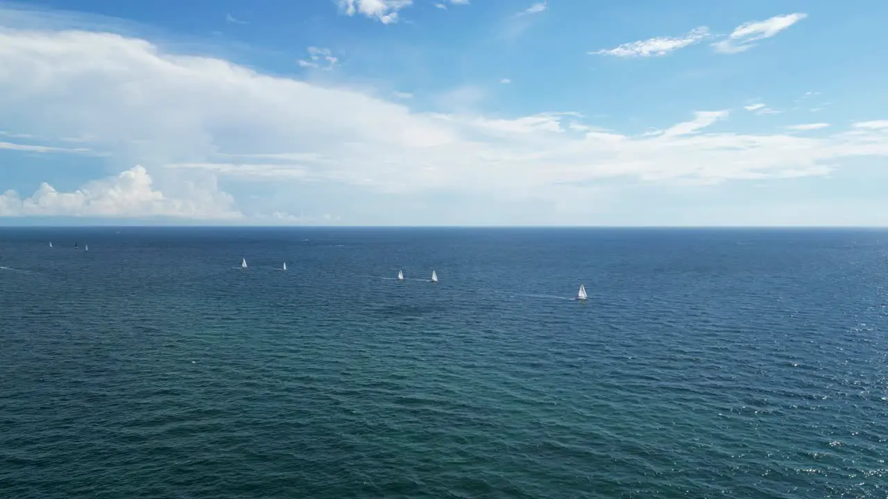 Far tracking shots of boats off the shore of a beach in Boca Raton FL