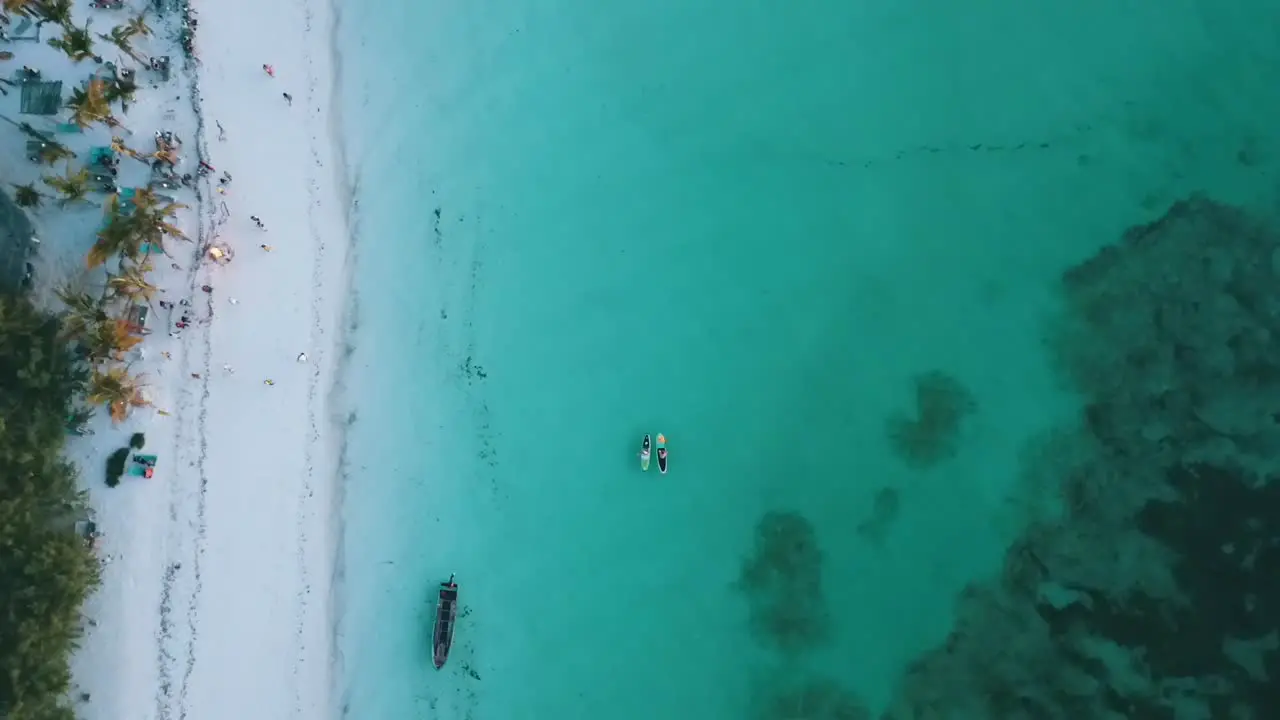 Marvelous bird's eye view top view stable tripod drone shot of random anonym people in a beach bar
Drone shot on Zanzibar at Africa in winter 2019