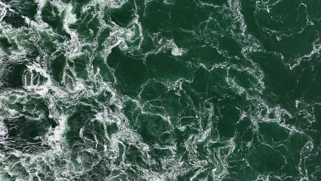 Aerial birdseye view of water frothing and mingling