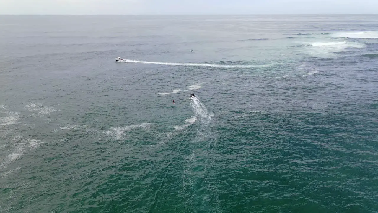 Hydrofoil Boat Towing Surfer On A Surf Board Water Adventure At Sharpes Beach Near Flat Rock NSW Australia aerial drone