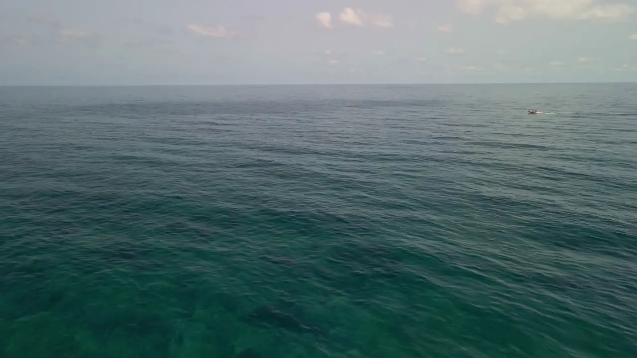 Aerial View of Tropical Crystal Sea with Speed on Background