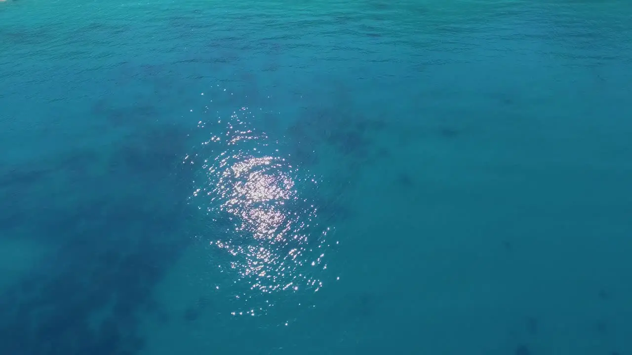 Aerial over beautiful blue Mediterranean ocean waters reveals Greek Island of Lefkada