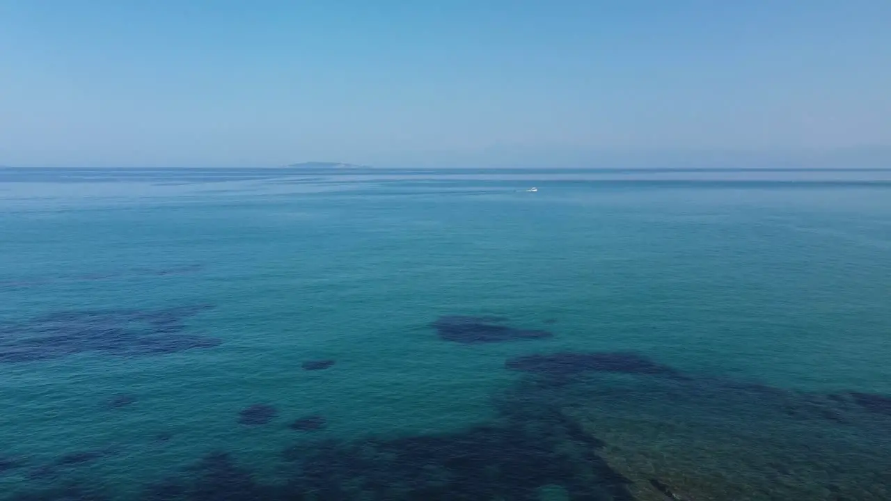 Calm deep blue ocean sea and blue sky Greek Island bay San Stefonos Corfu drone View