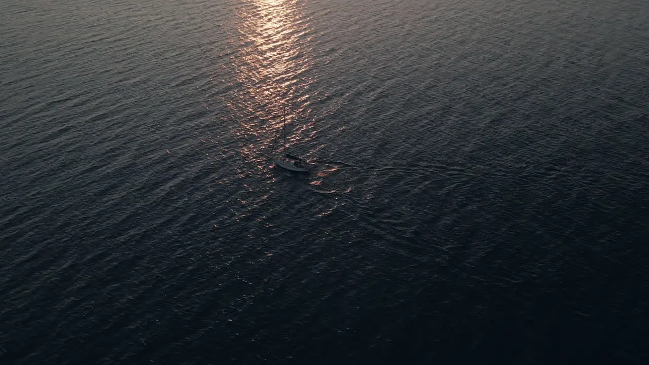 Sailboat Sailing On The Calm Sea With Reflections Of Sky Shining On The Water Surface During A Sunrise In Quebec Canada