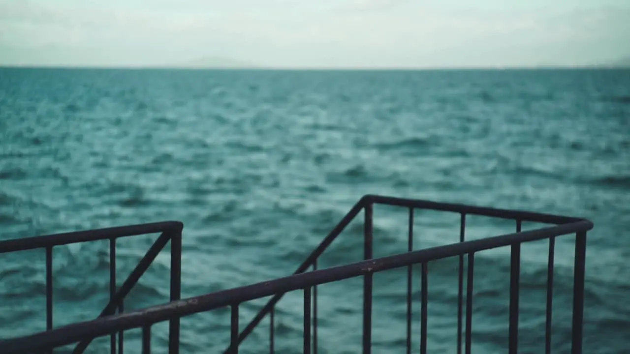 Selective Focus Shot Of Steel Railing By The Sea With Wave Motion In The Blurry Background In Shiga Japan slow motion