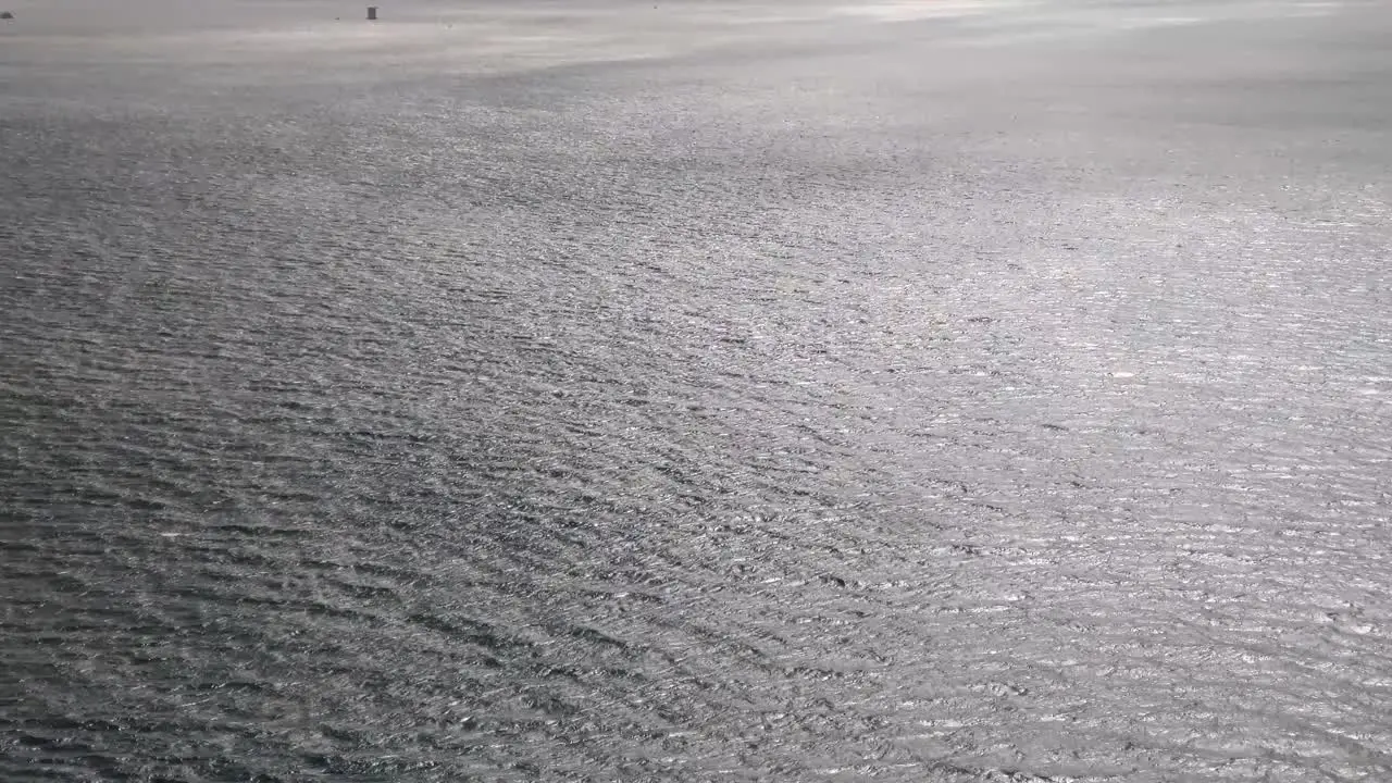 Aerial view to ocean waves Rippled water with birds flying over surface