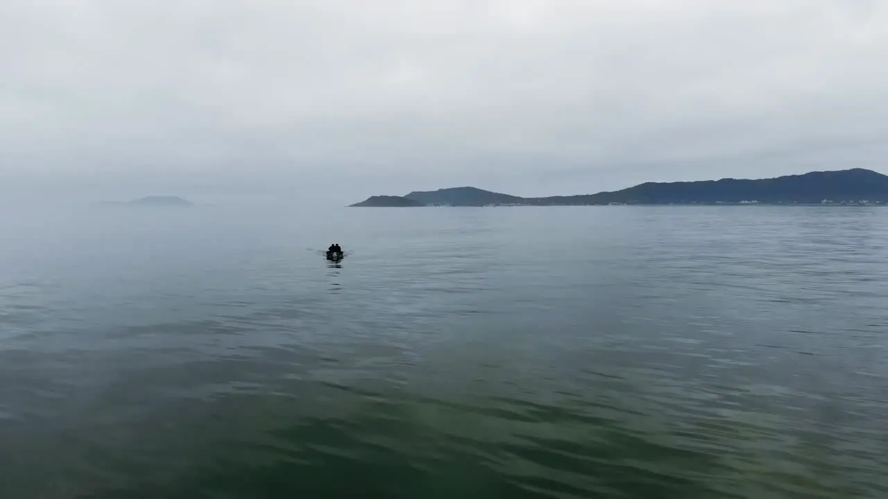 Aerial view showing tourist in boat cruising on mystic ocean in Brazil