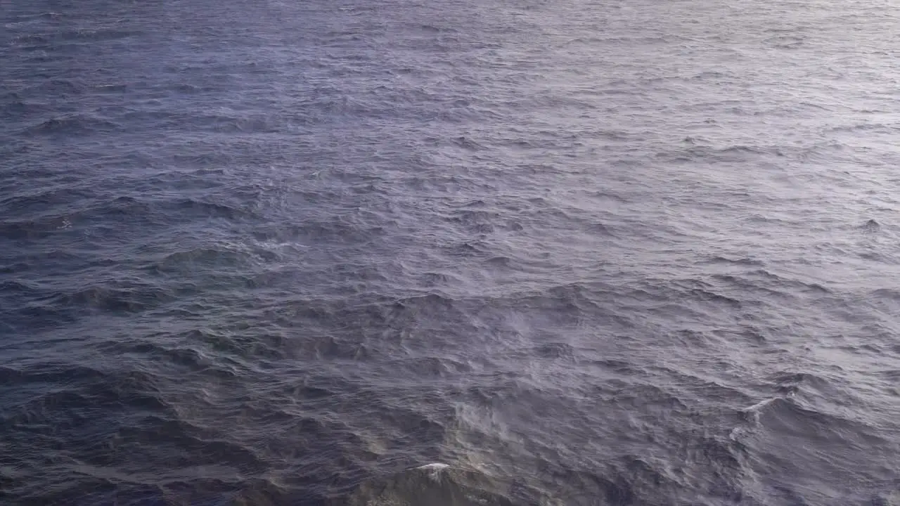 Slow motion view of Ocean Surface slowly passing by from ship