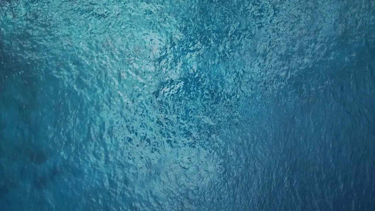 Aerial top down view of blue ocean surface turquoise sea water background