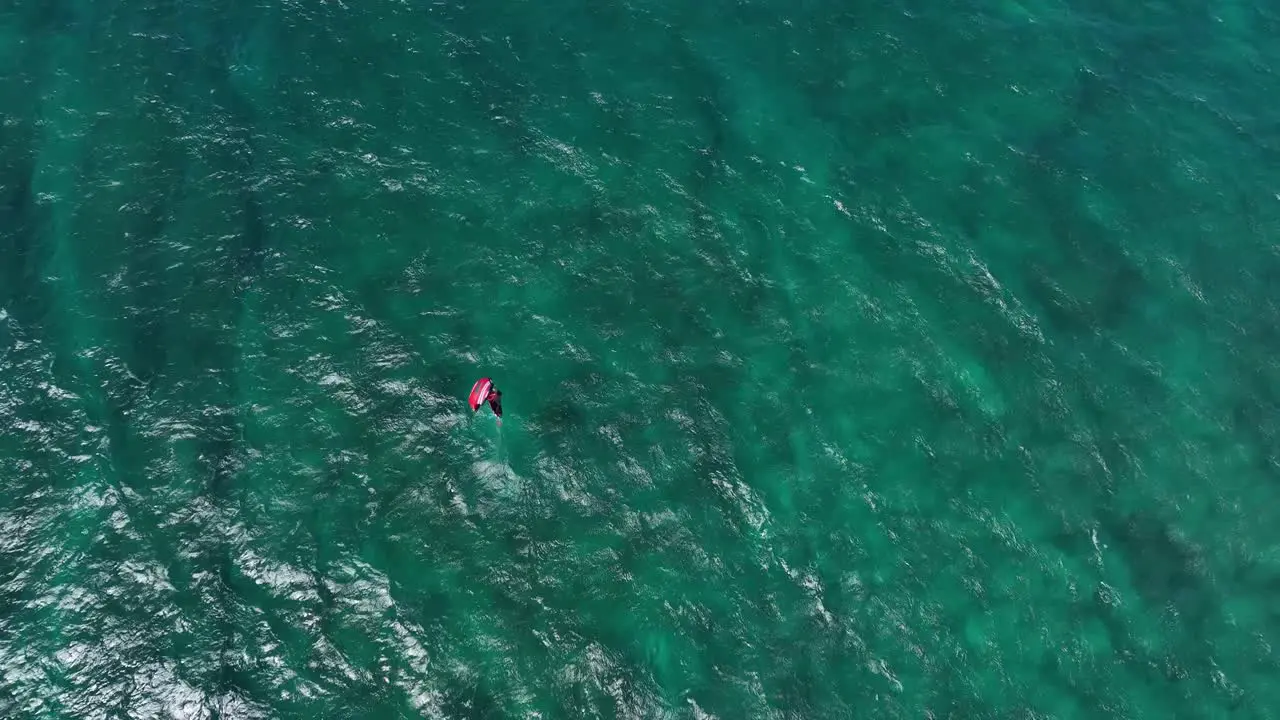 Wing foiler cruising wide open clear turquoise Hawaiian waters Hookipa overhead