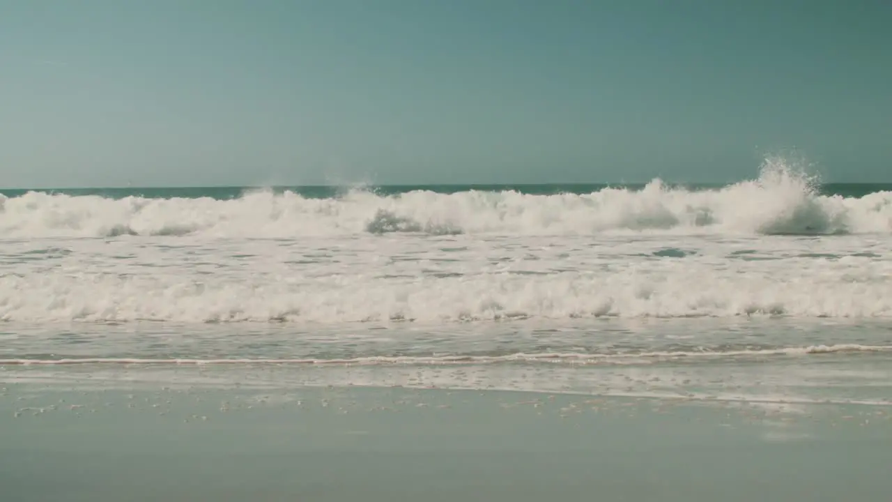 Huge waves break on the shore of a beach in Nazarè Portugal