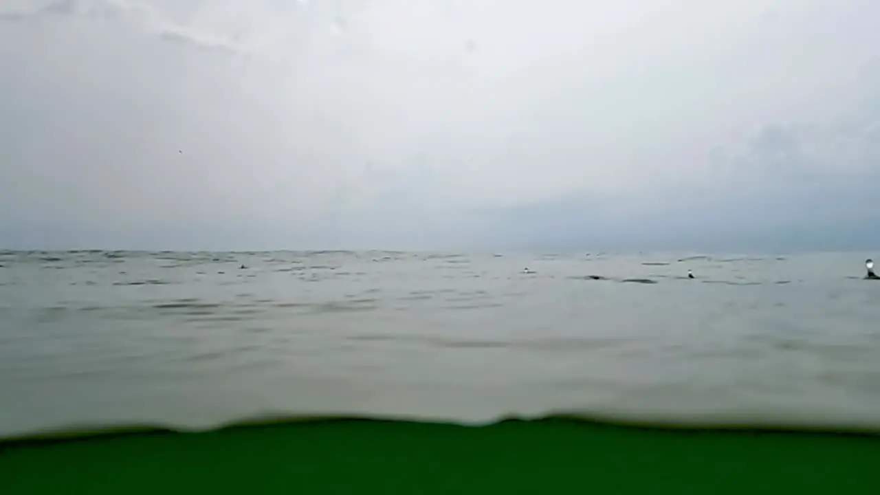 Raindrops on sea surface and horizon in background