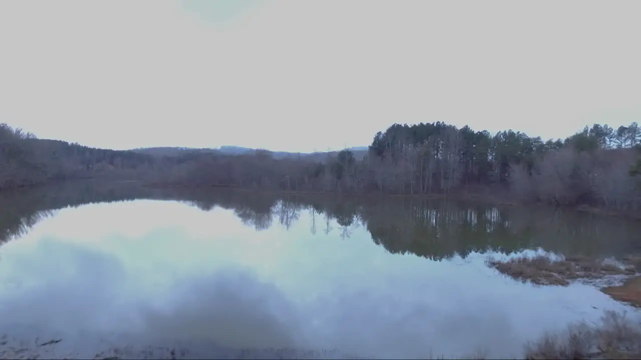 A drone flyover of a masked man on a levy