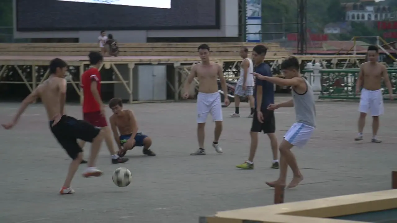 Men Playing Soccer in Street 4