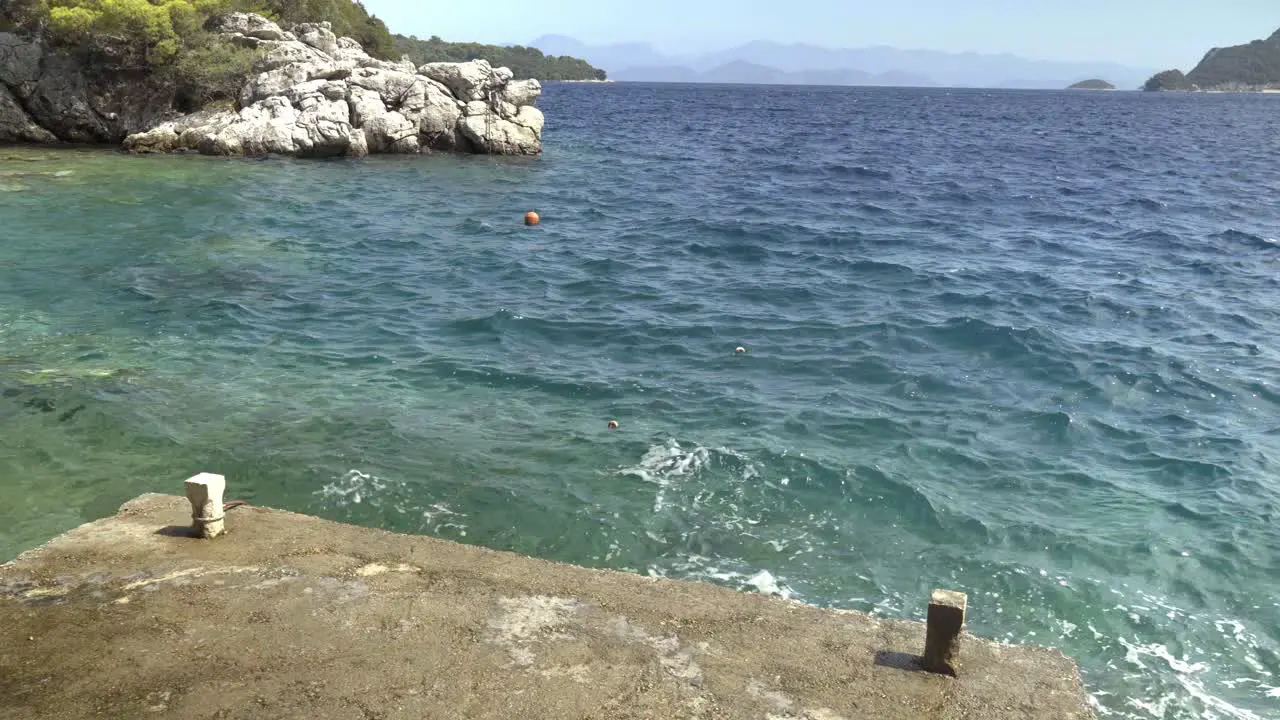 Waves hitting a concrete pier in an alcove on Mljet Island Croatia in the Adriatic Sea