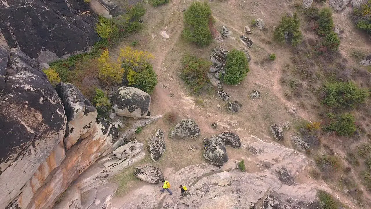 People hiking on a rocky mountain drone shot