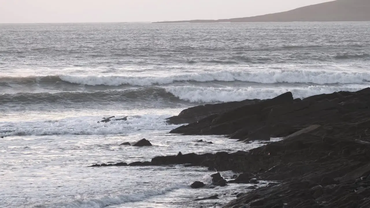 Winter ocean with rolling waves and rocky coast in Ireland