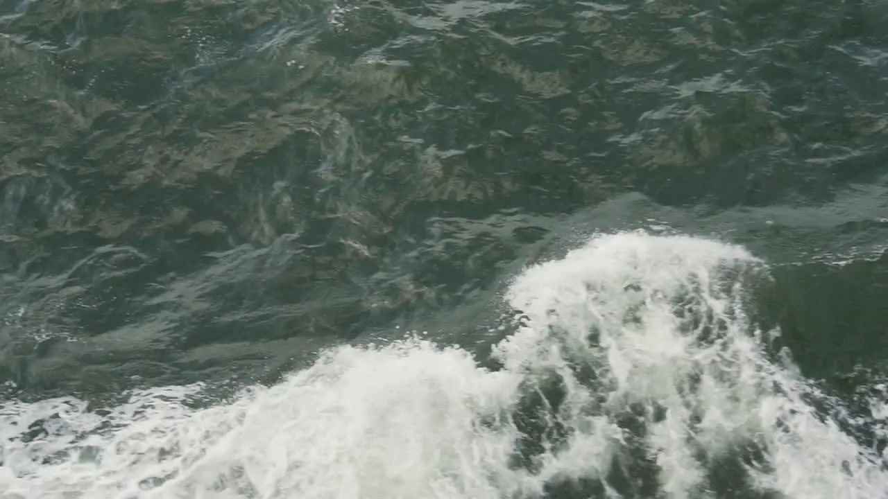 Slow Motion of Sea Waves by Sailing Boat Top Down View