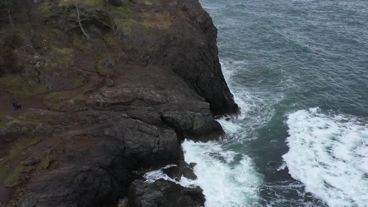 Aerial view of rough waters against the cliffs in the pacific northwest