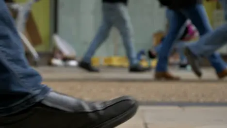 Defocused Long Shot of Feet Walking Past Homeless Persons Belongings In Doorway 01