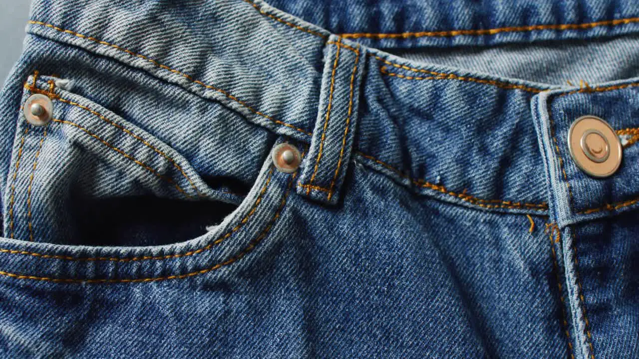 Close up of jeans on grey background with copy space