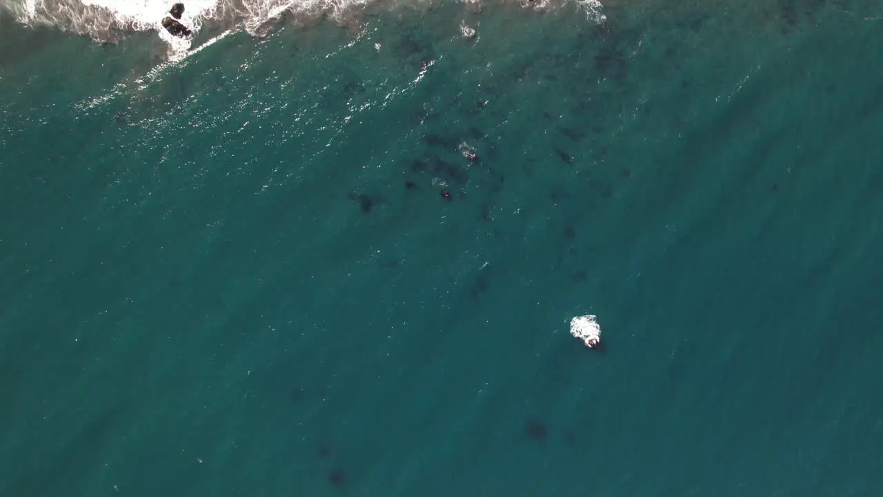 Aerial Over Turquoise Ocean Waters Towards Beach Coastline And Cliff Face At Matanzas Chile