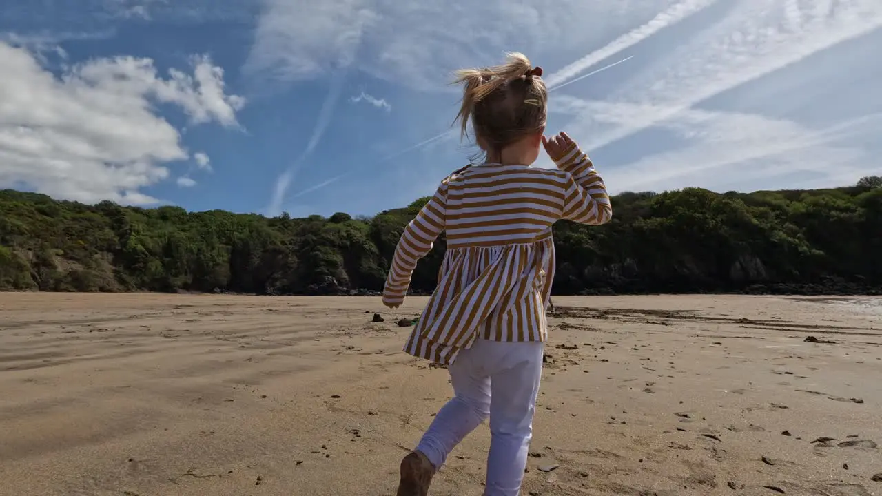 Toddler run over sunny beach