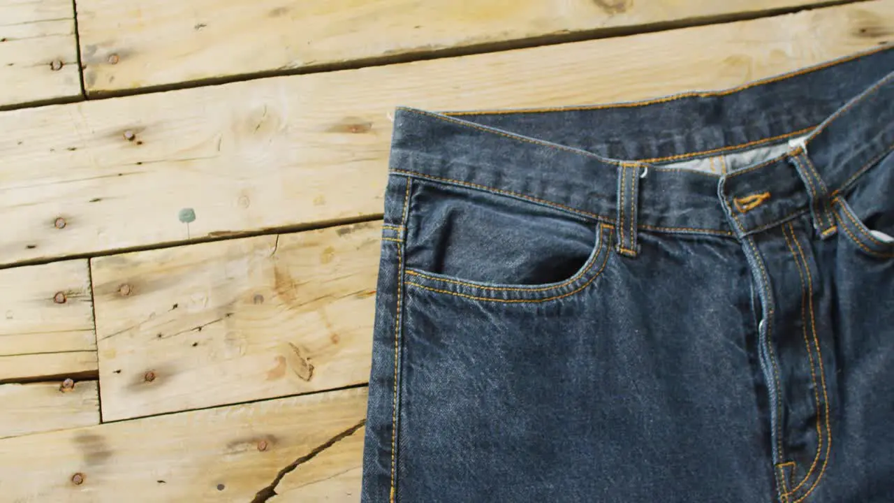 Close up of jeans on wooden background with copy space