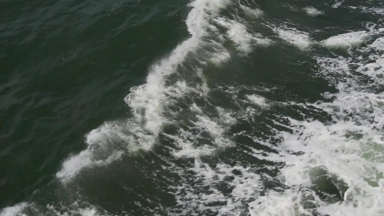 Slow Motion of Ocean Waves from Sailing Ship Abstract Top Down View