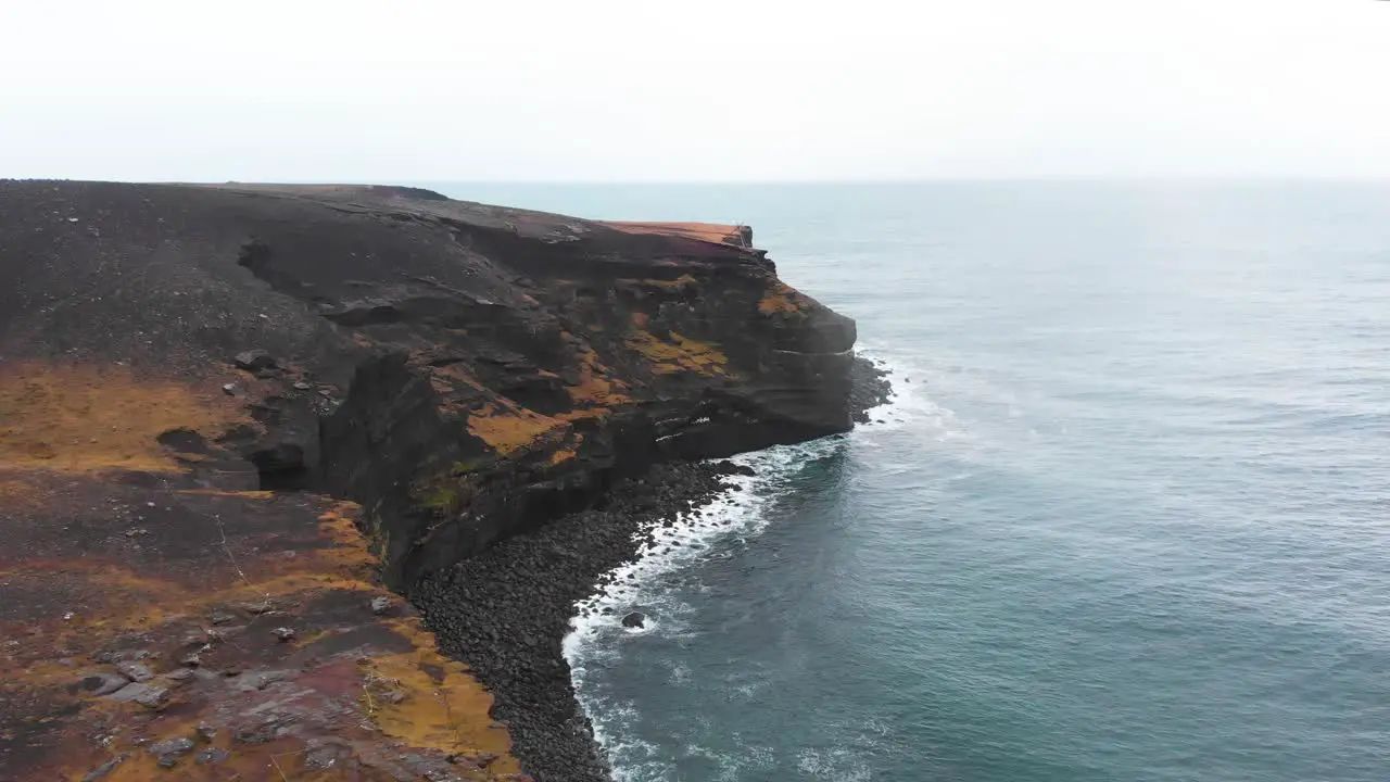 Volcanic Krísuvíkurberg cliffs above atlantic ocean waves Iceland