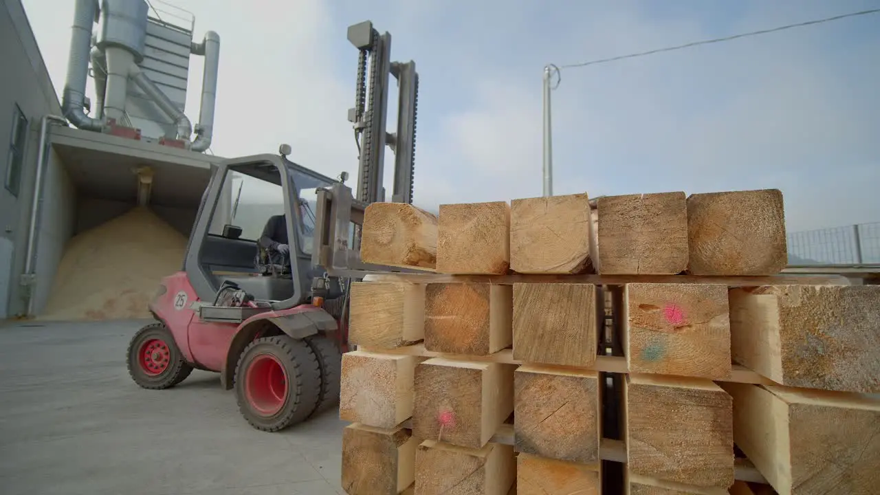 Forklift Stocking Tree Trunks In Pile One Over Each Other