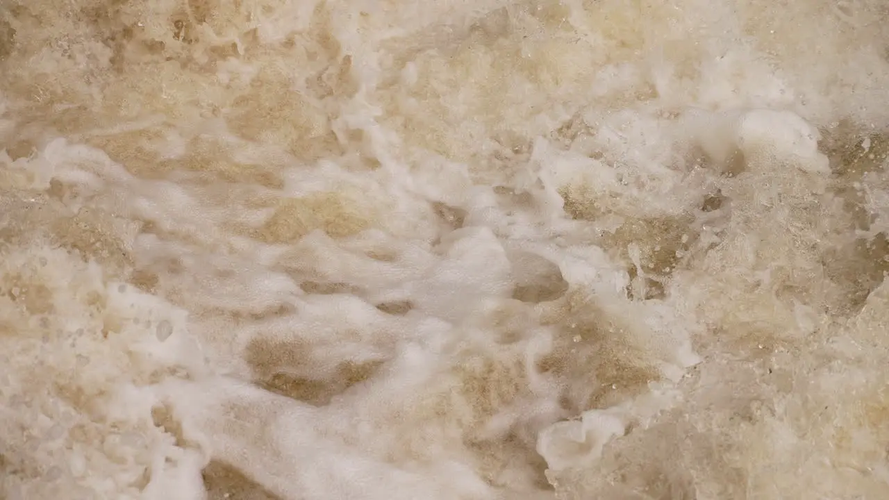 Water rushes down river rapids in a powerful force slow motion