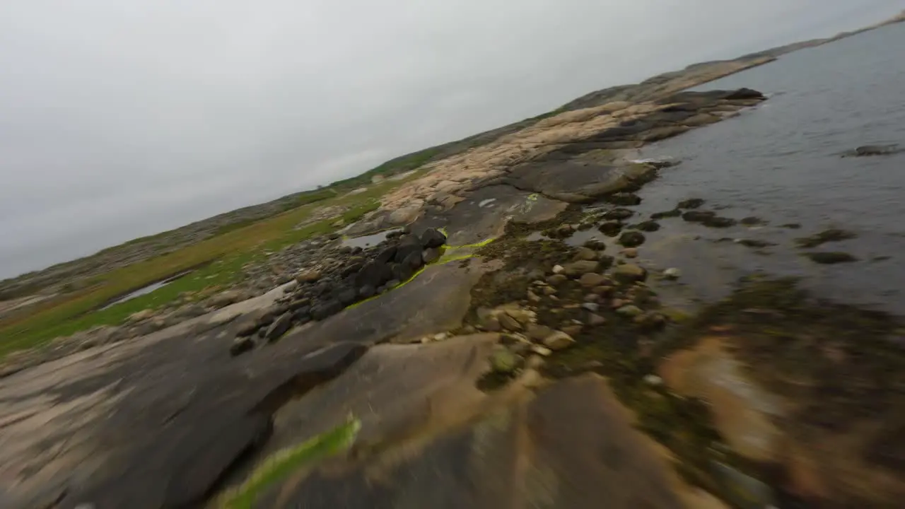 FPV drone manoeuvres at low altitude over the shoreline of Ramsvik in Sweden