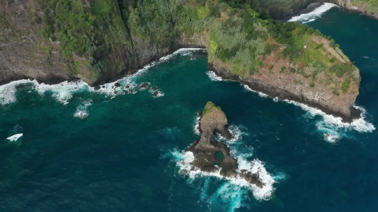 Scenic cliffs of Atlantic Ocean island with stunning blue water and waves