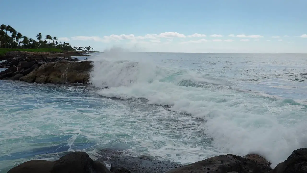 Waves crashing over Oahu's the volcaninc rocks